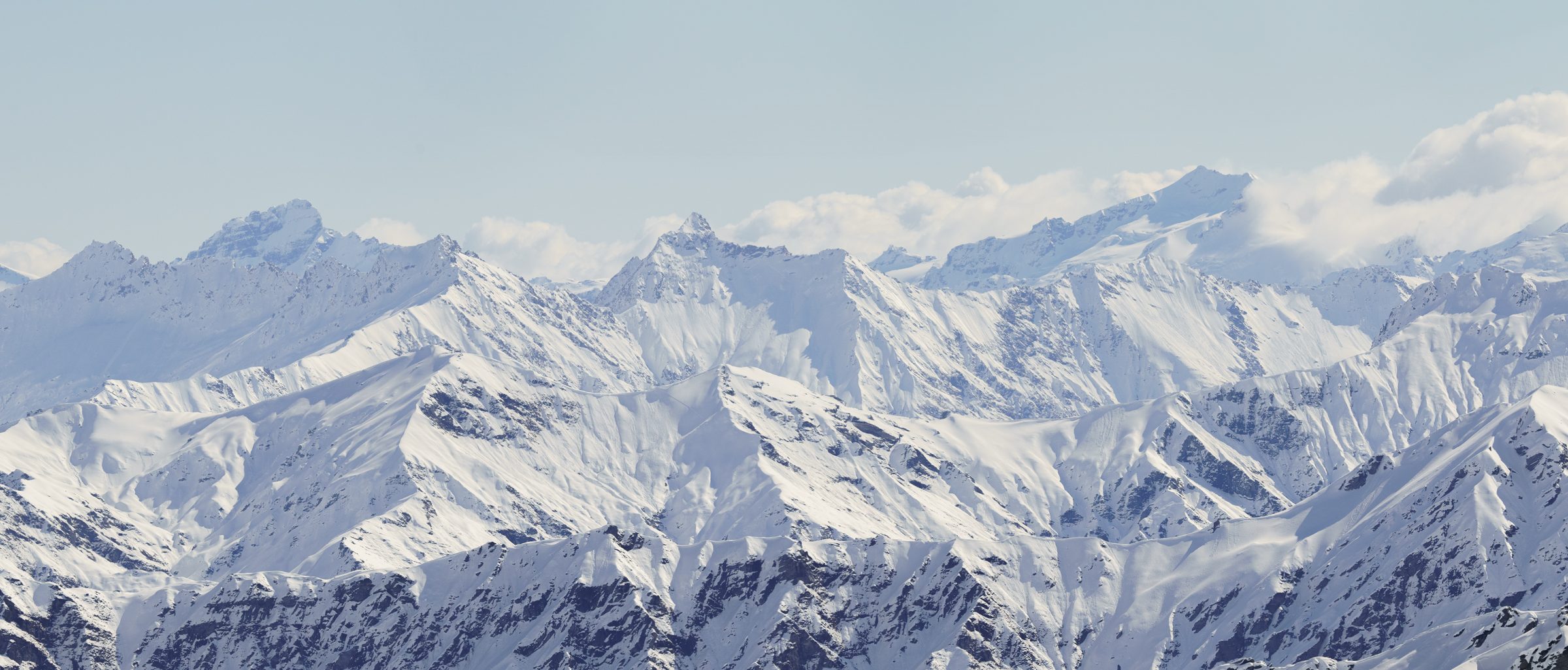 Snow-covered Southern Alps stretching across the horizon — the Mt Hutt ski shuttle destination